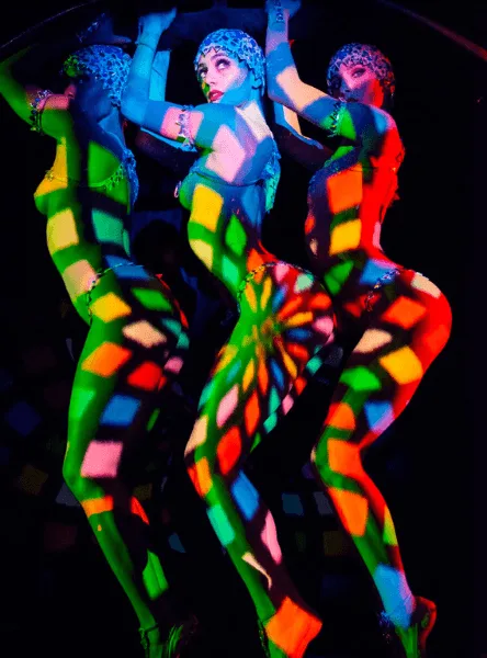 Colourful projected light across a Crazy Horse costume