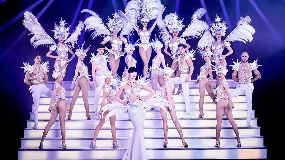 Paradis Latin dancers wearing white feather costumes